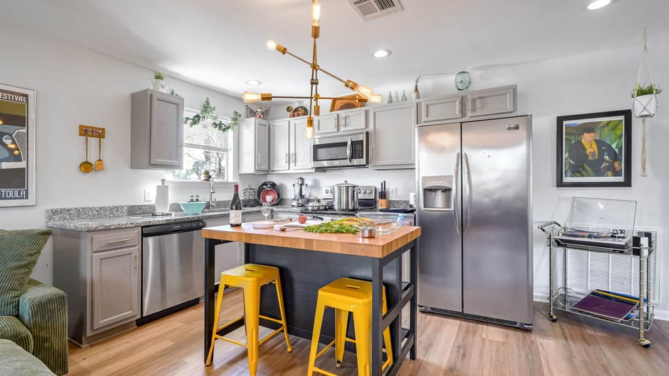Fully equipped kitchen with a dishwasher, coffee, sugar, creamer, and filtered water