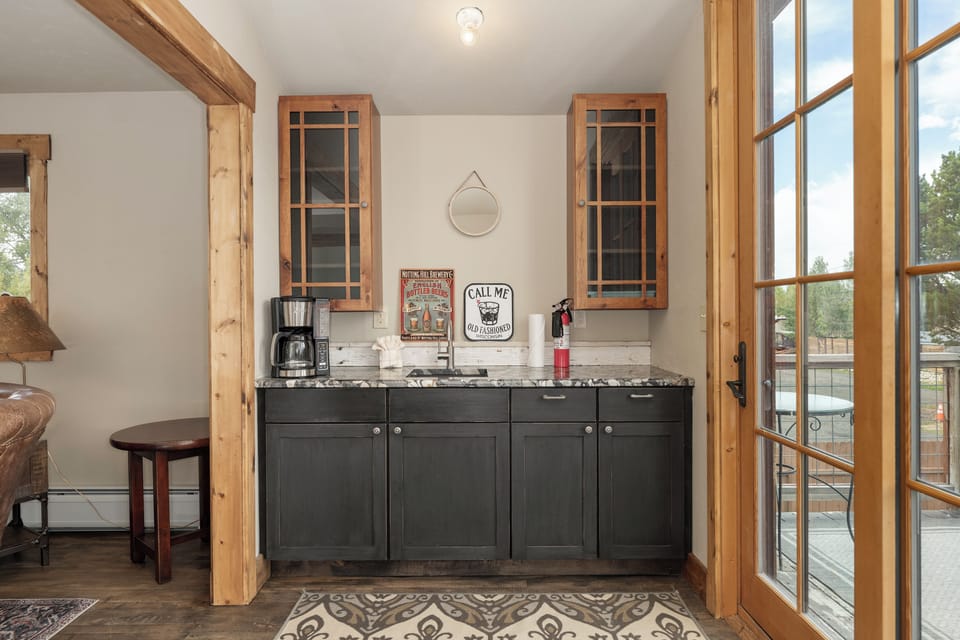 Your rustic kitchen features charming wood beams, granite counters, and vintage-inspired details for memorable mornings.