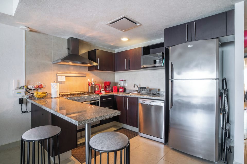 The kitchen is equipped with stove, oven, dishwasher and microwave