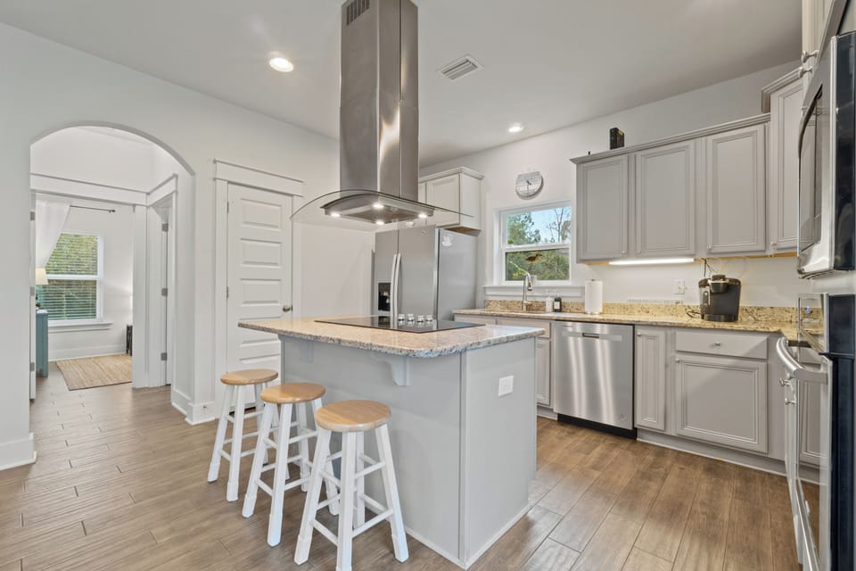 Well stocked kitchen with view of main floor bedroom beyond.