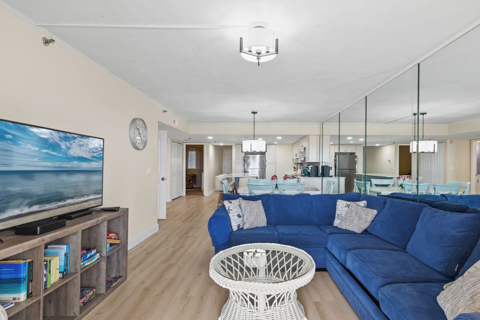 As you enter, you are welcomed into the Den with a clean, crisp decor and Beachy Floors giving this home a positively serene feel.