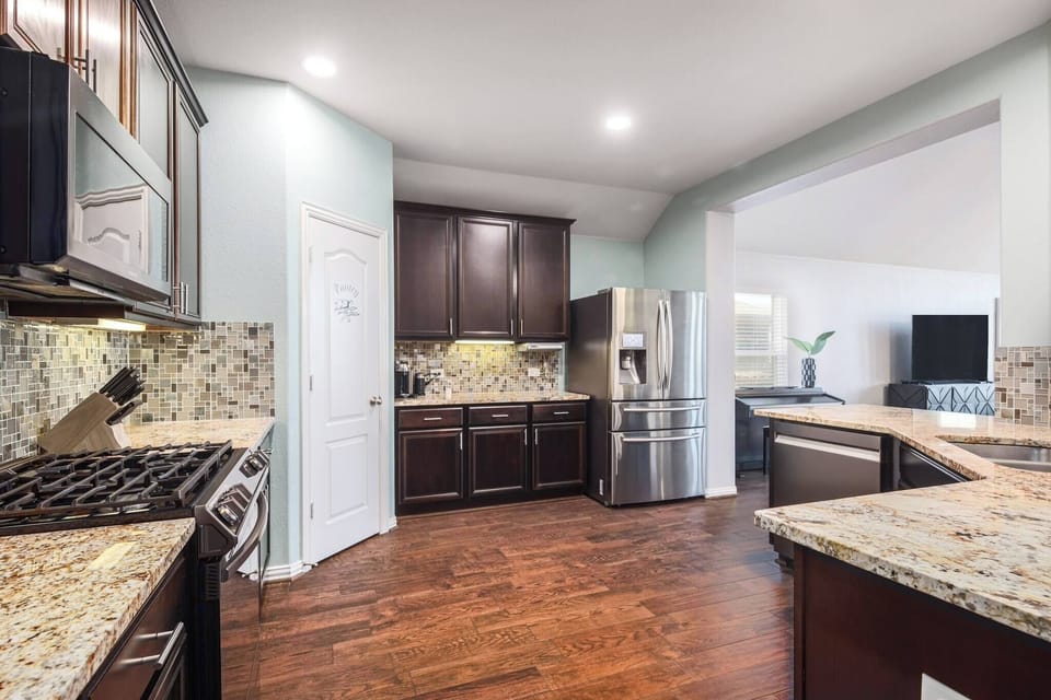 The gourmet kitchen is fully equipped with pots, pans, utensils, tableware, and more.