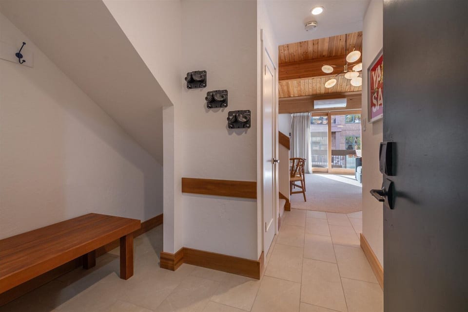 Front entryway newly equipped with wall-mount ski racks, coat racks for all your winter gear, and a bench for ease of use when taking your boots on and off.