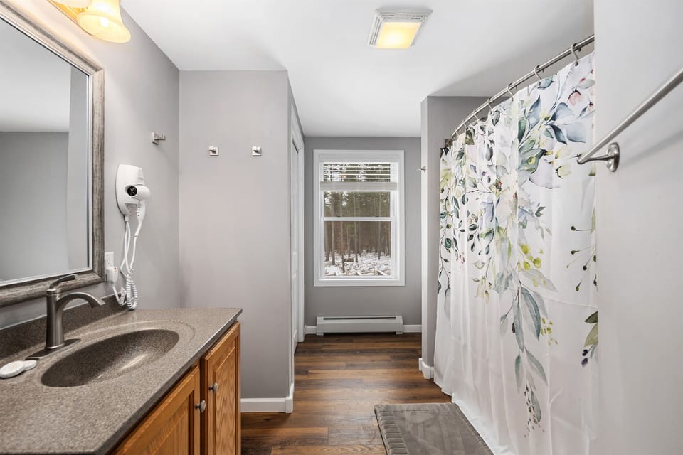 The 2nd-floor bathroom features a shower/tub combination with a rainfall shower head. A hairdryer is provided for your convenience. 
