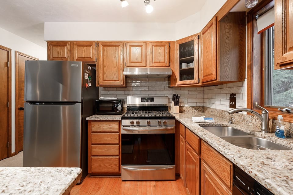 Bright kitchen w/ granite counters, stainless appliances & plenty of prep space