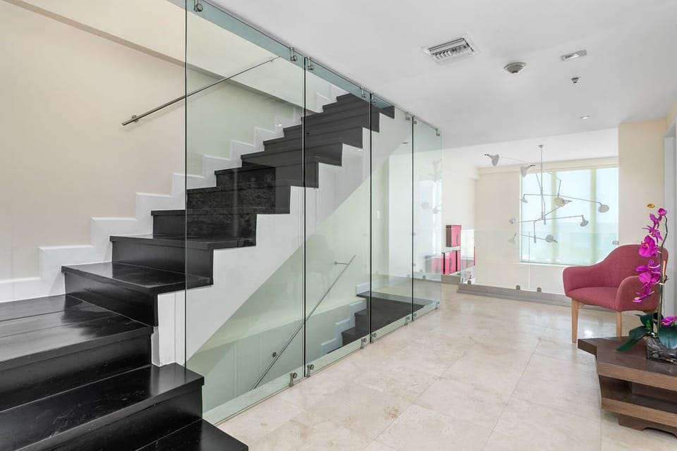Ascend in style with these stunning stairs, featuring sleek glass railings that add a modern, open feel to the home. The design creates an airy, sophisticated atmosphere, blending functionality with contemporary elegance.