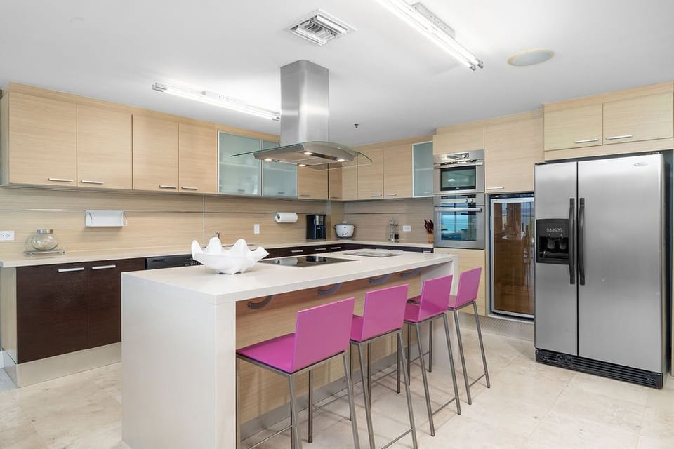 This modern kitchen features a sleek 4-seating island counter, perfect for casual meals, entertaining, or enjoying a morning coffee. The open design creates a functional yet stylish space for cooking and socializing.