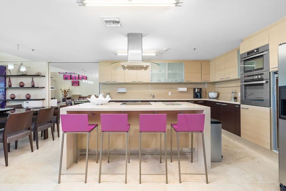The stylish kitchen features sleek countertops, high-end appliances, and ample storage space. Perfect for preparing meals or entertaining, it combines both functionality and contemporary design.