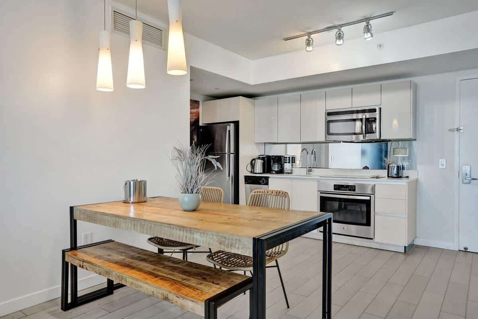 Open space dining area and a fully equipped kitchen with stainless steel appliances to enjoy meals with friends and family