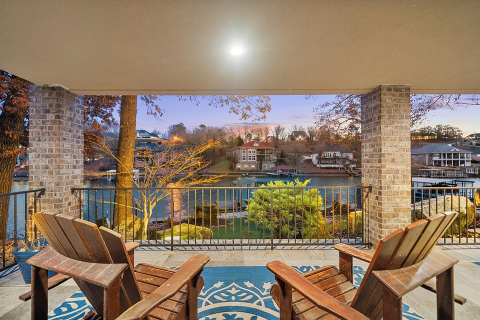 An inviting covered patio with cozy seating and beautiful nighttime views, perfect for unwinding after a busy day.