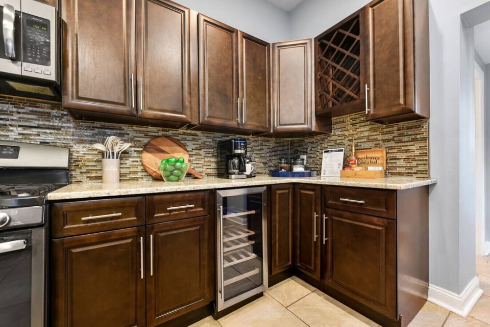 A beautifully stocked kitchen with ample storage and a dedicated space for your wine collection.