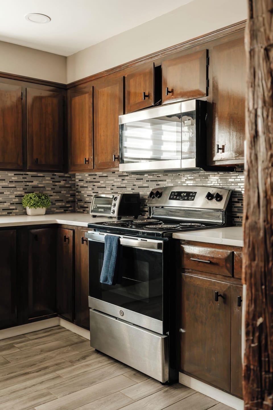 Cook up breakfast on the electric range, with a toaster oven on the counter for anything that needs a quick reheat. The tile backsplash and wood cabinets give this kitchen a warm, lived-in feel.
