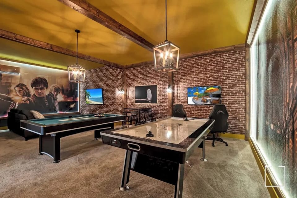 Experience fun and excitement in this themed game room with pool and air hockey tables, perfect for family entertainment!
