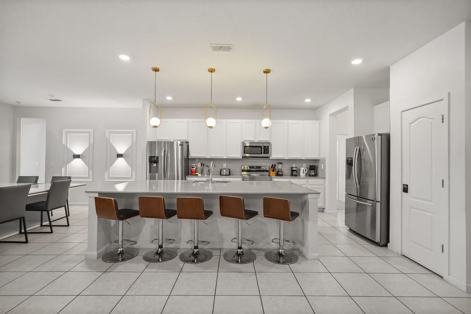 Modern kitchen with a large island and sleek appliances, perfect for entertaining in style.