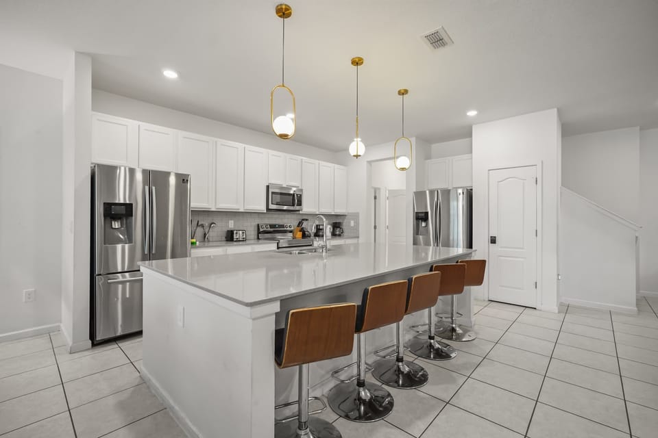Spacious modern kitchen with sleek appliances and a large island, perfect for entertaining and family gatherings.