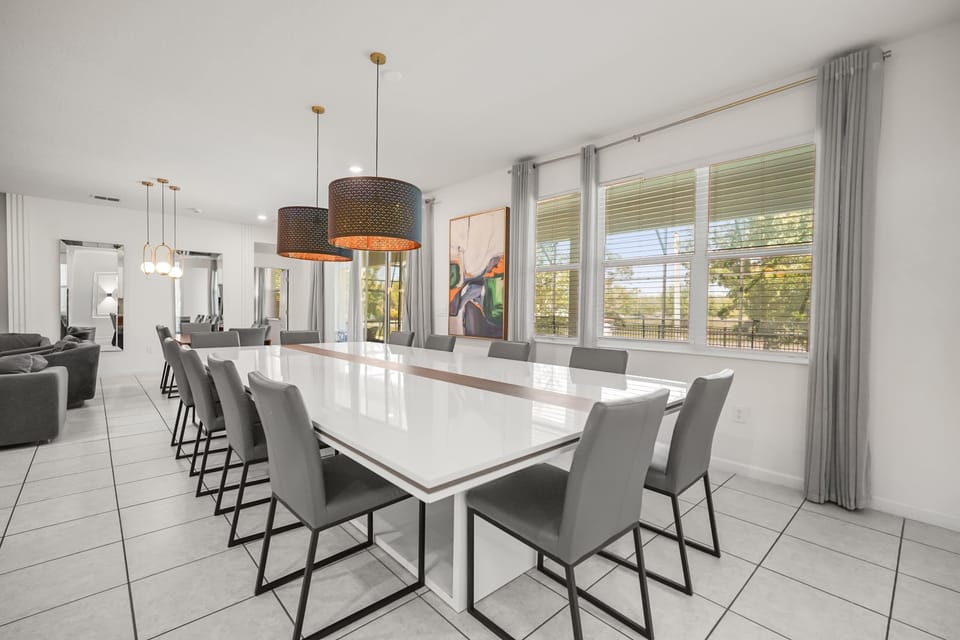 Elegant dining area perfect for large gatherings, featuring a sleek table and modern lighting.