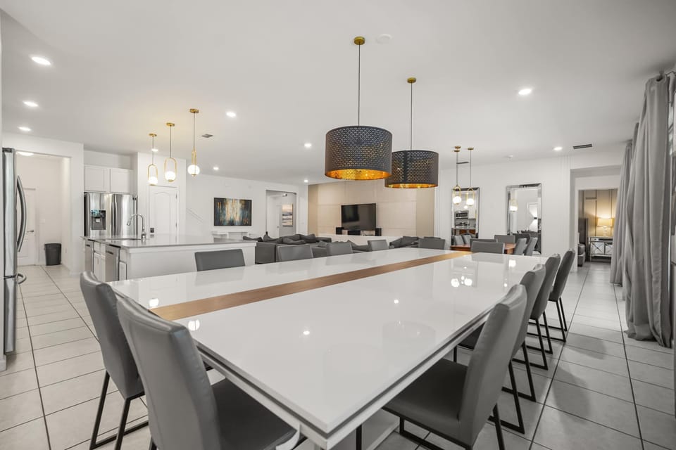 Expansive dining area perfect for large gatherings, featuring sleek modern design and ample seating for all guests.