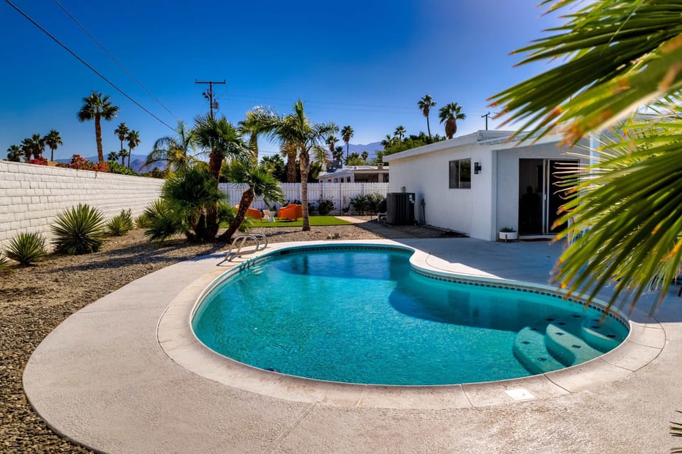 A private backyard oasis with pool and outdoor seating