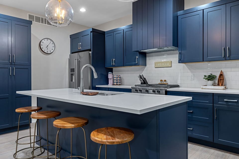 Blue cabinets, white countertops, and a whole lotta style—who needs takeout with a kitchen like this?