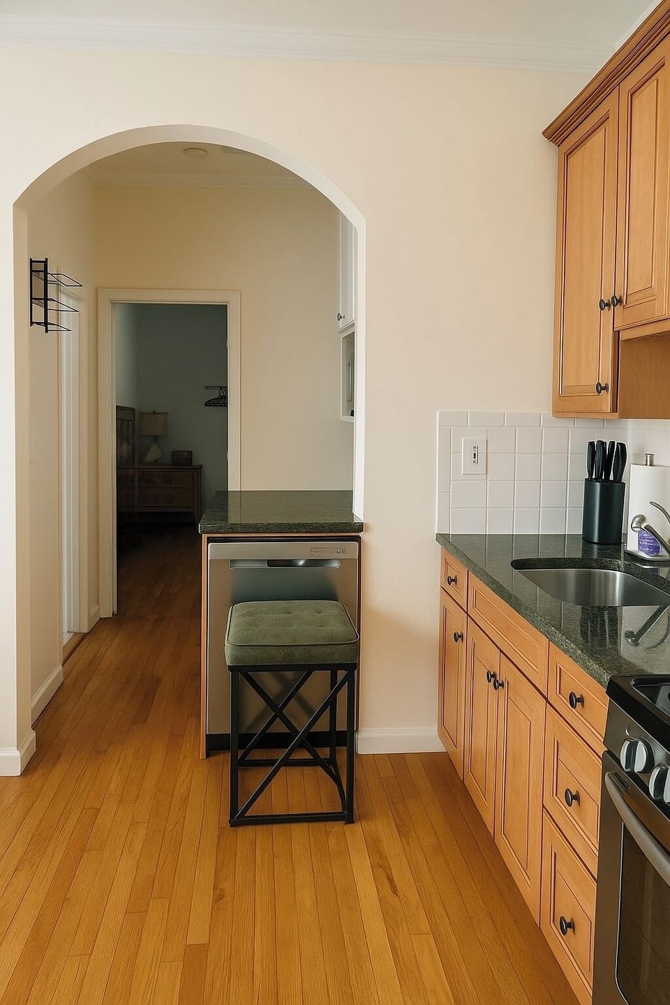Fully equipped kitchen with archway and natural light