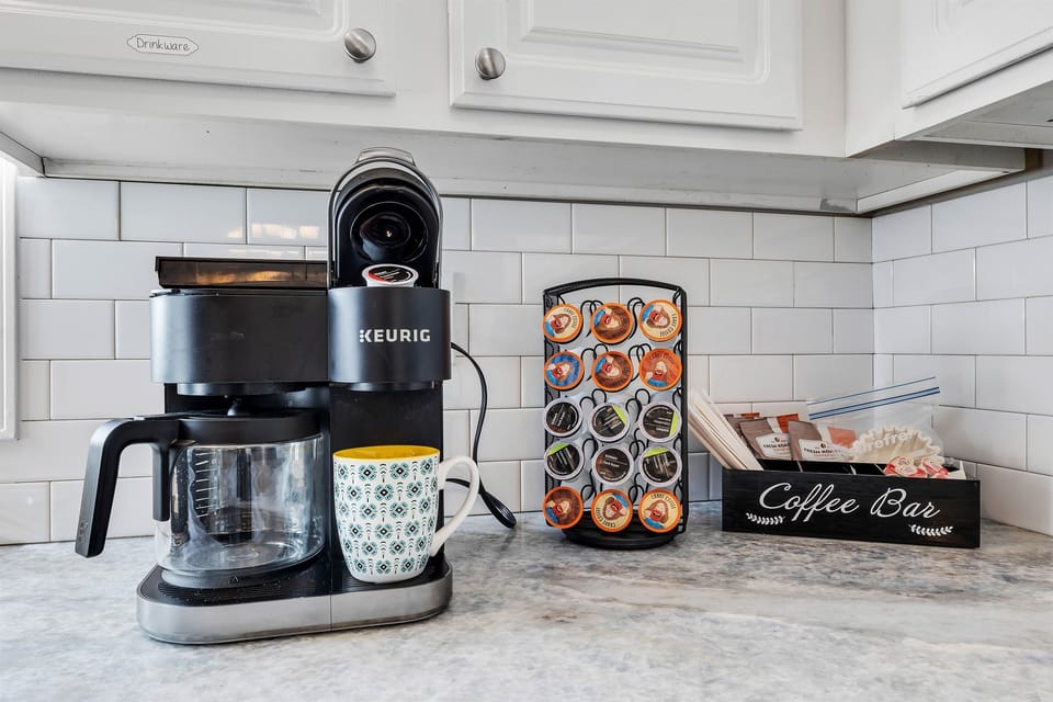 Rise and shine with a coffee bar featuring a Keurig Duo, stocked with K-Cups and ground coffee for a perfect morning brew.
