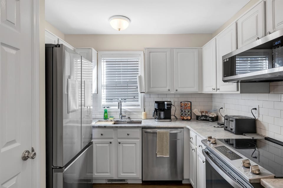 The kitchen with all stainless steel appliances and a pantry for your dry goods.