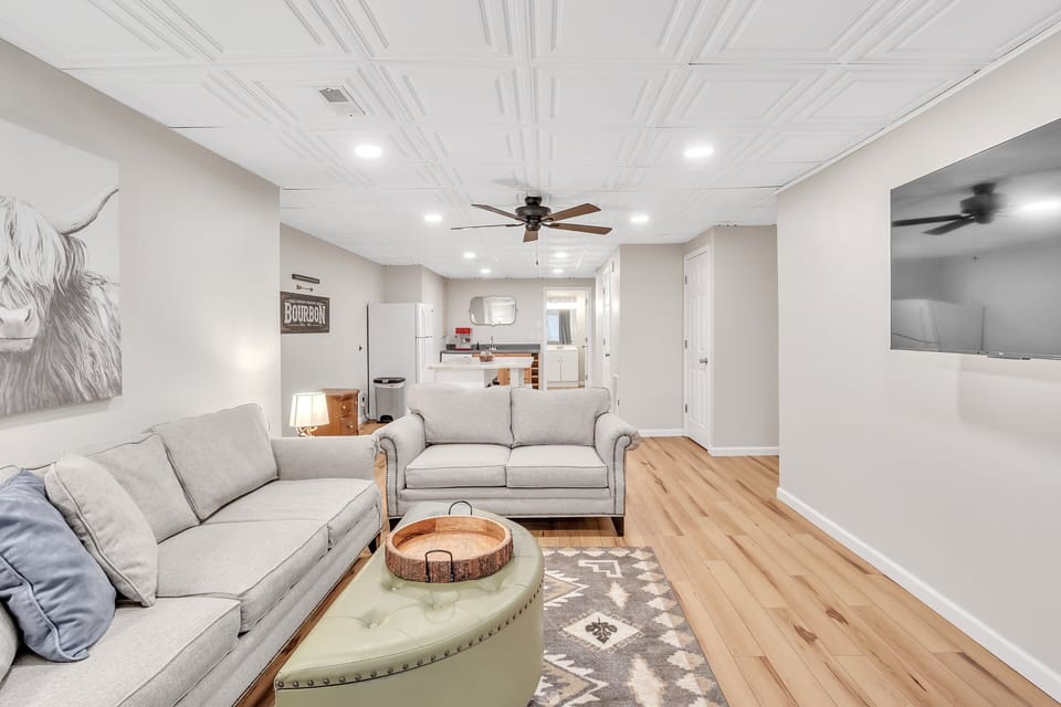 Basement living space, game table, wet bar, and extra fridge.