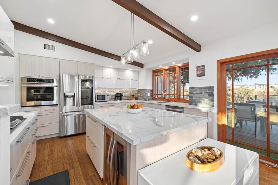 Bright kitchen with a marble island, ready for your culinary adventures.
