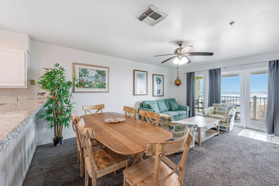 Your bright living space flows seamlessly from dining to relaxation, with beach views from your private balcony creating the perfect coastal retreat.