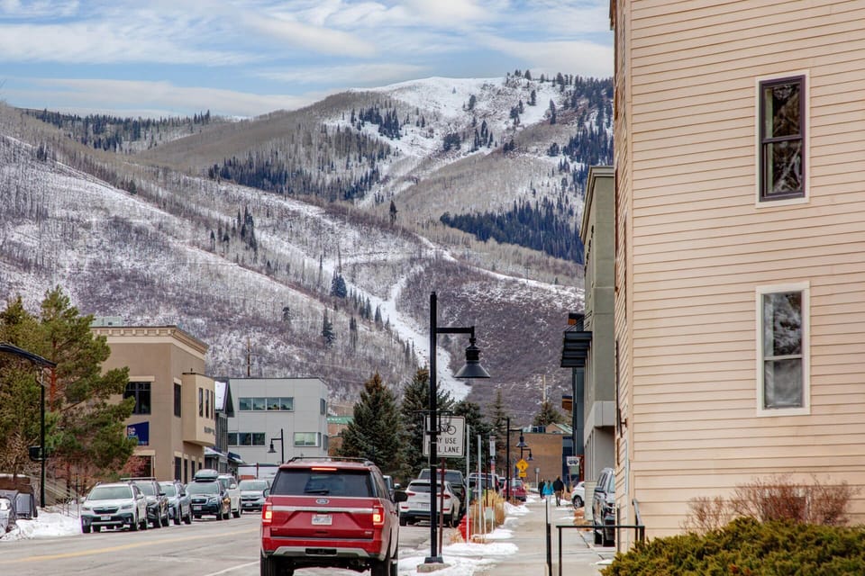 A charming mountain town setting with stunning snow-covered peaks rising above the property, offering a quintessential winter escape in a welcoming community.
