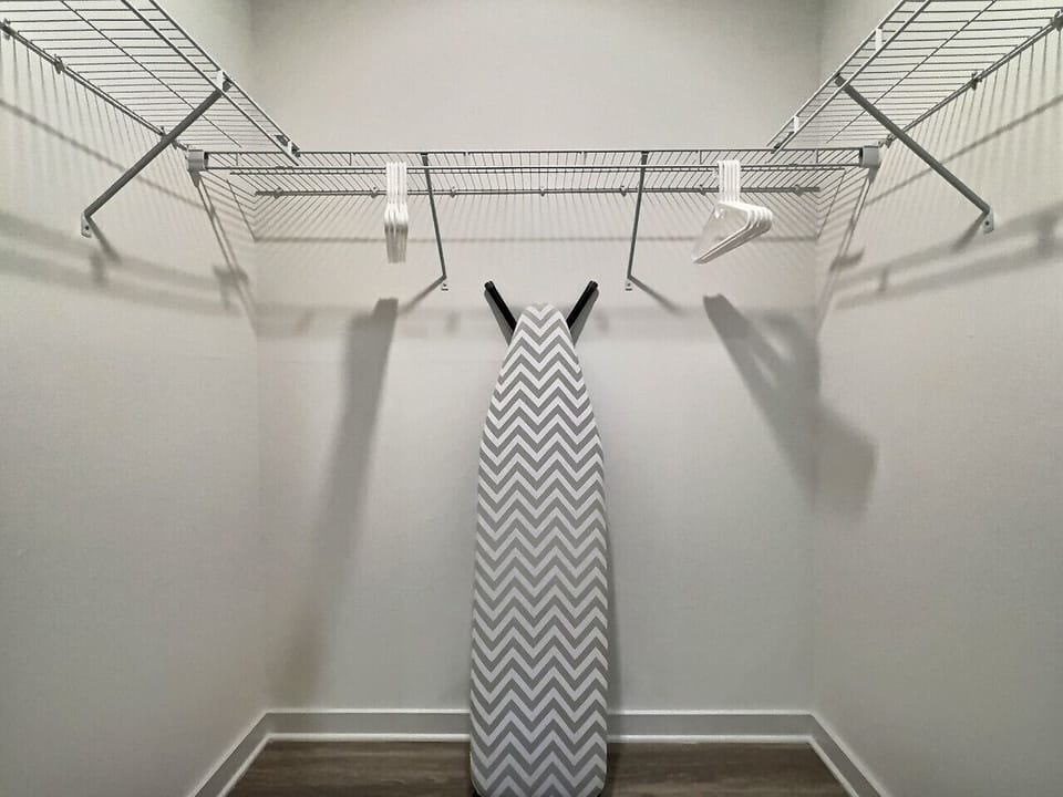 Minimalist iron stand, the perfect spot to hang clothes neatly and stay organized during your short-term rental stay.