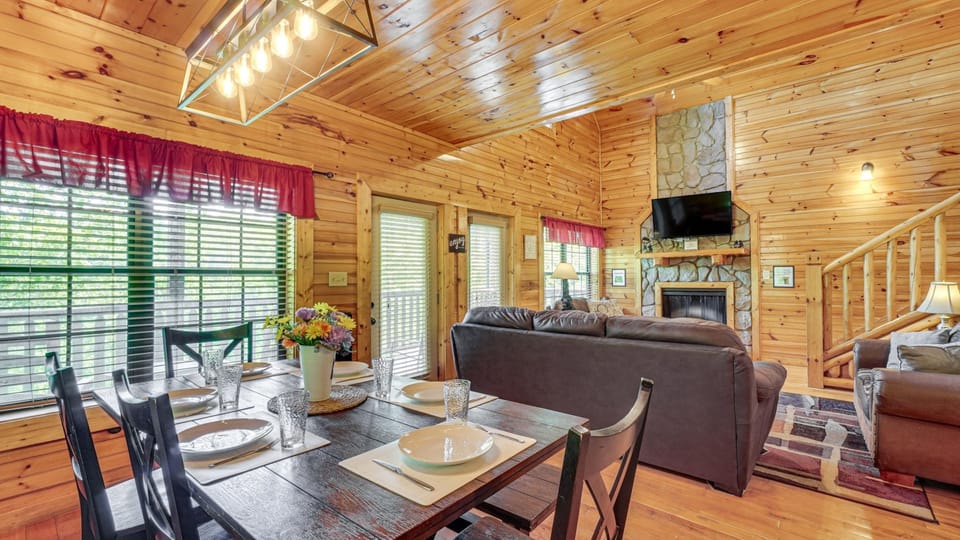 Open dining and living area with fireplace and sleeper sofa seating
