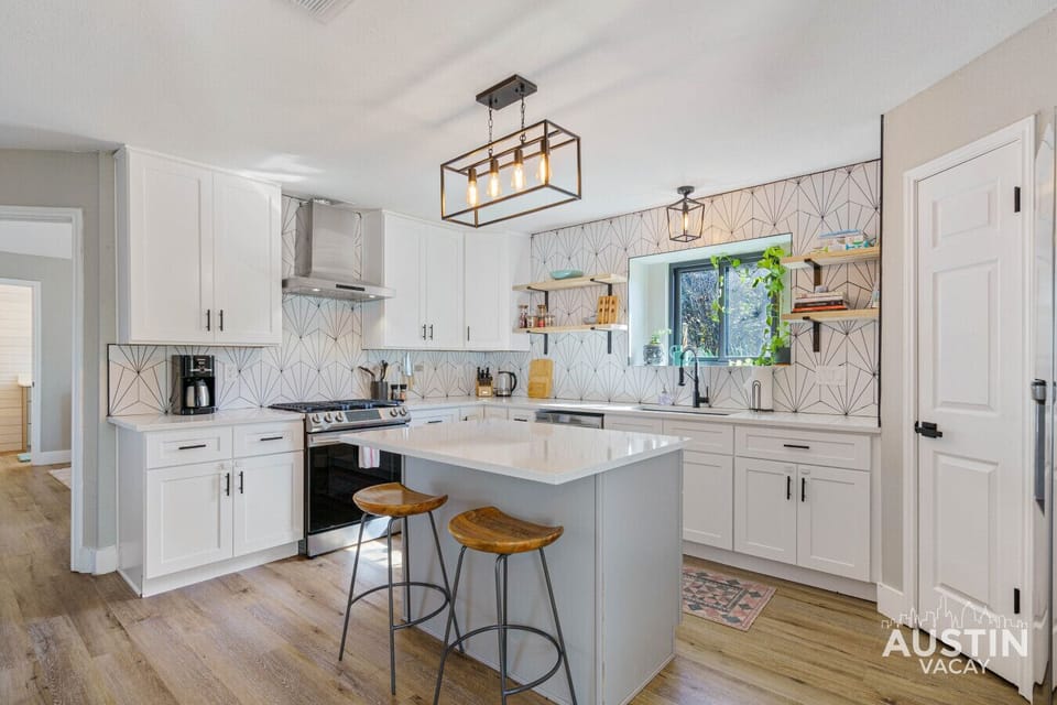 Whip up delicious meals with a view! This bright and airy kitchen offers everything you need to create culinary delights, including a spacious island and a lovely view from the window.