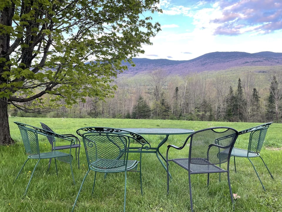 Outdoor seating with view of Hunger Mountain and Hogback Mountain.