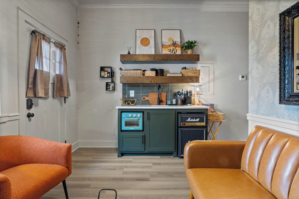 Separate living room with full size sofa sleeper and tiny kitchen