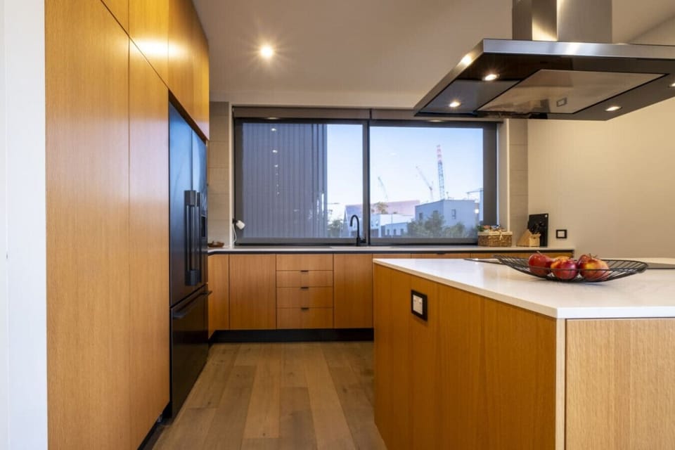 Prepare your meals in your sleek kitchen with premium appliances and sweeping city views across your countertop.