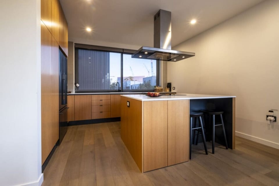 You`ll love cooking in your sleek modern kitchen, with its warm timber cabinetry, island bench, and those sweeping city views.