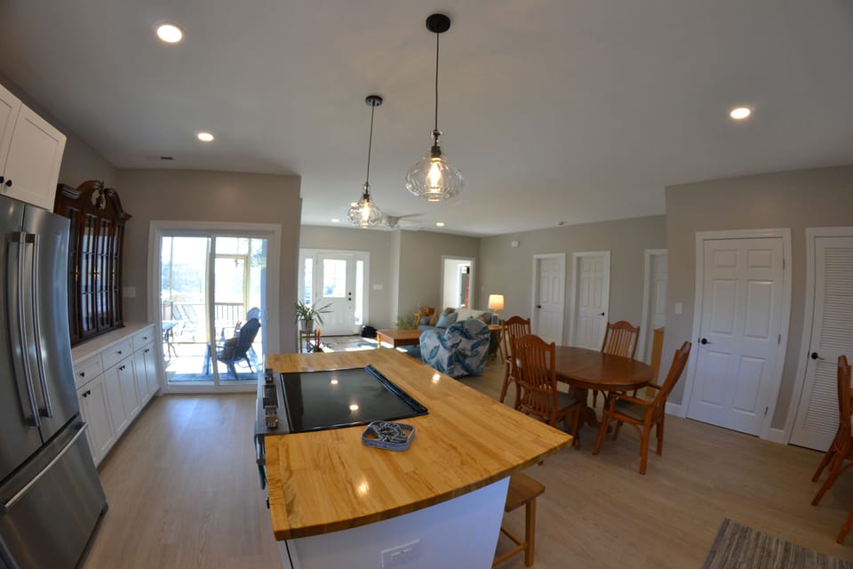 Kitchen w/ fridge, DW, & stove/oven in large island w/ access to screened porch