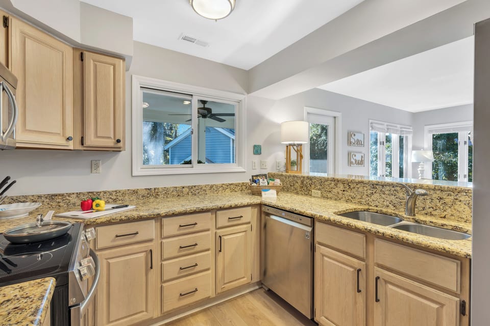 Fully equipped kitchen with pass-through window to the porch.
