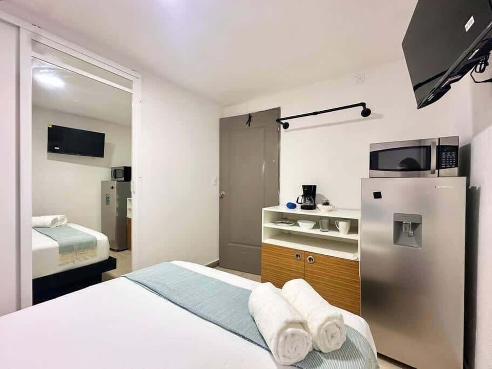 Efficient studio blending a comfy bed with a handy kitchenette, smart living in downtown Cancun