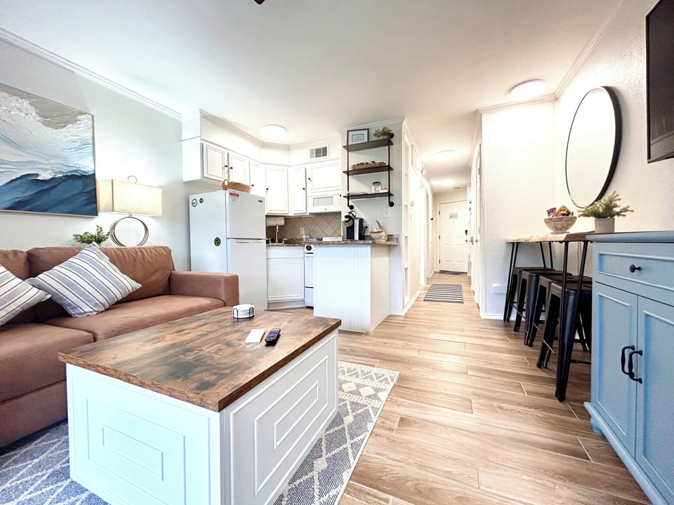 Open living space boasts tile floors, ceiling fan, and elevated design.
