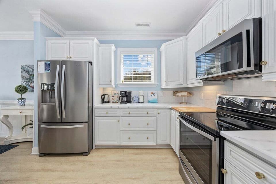 Modern kitchen featuring sleek stainless steel appliances. The perfect blend of style and functionality awaits you