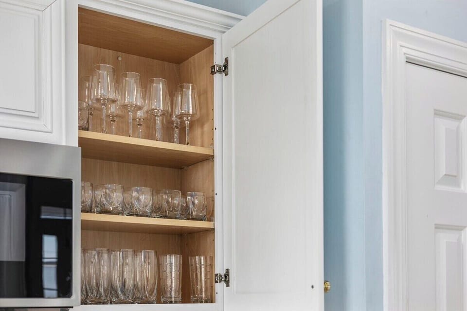 Our kitchen cabinet showcases a collection of glasses, perfect for any occasion. Cheers to fine moments!