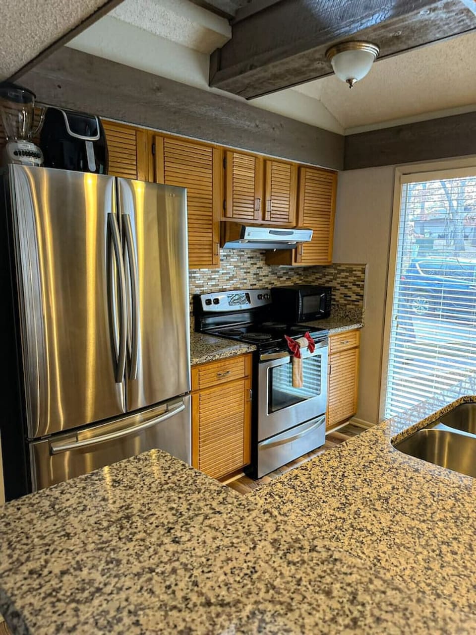 Cook like a pro in this fully equipped kitchen, featuring sleek stainless steel appliances and granite countertops!