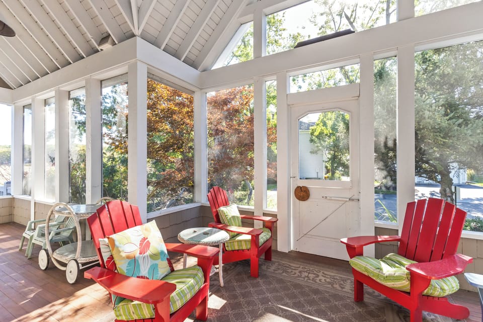 The sunroom on the front porch is a great space to read, offering a bright, peaceful environment.