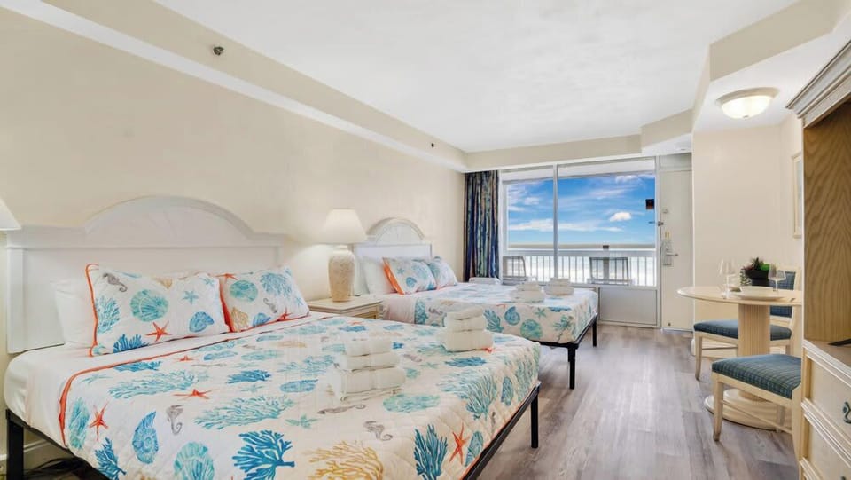 Bright guest room with ocean view and coastal-themed decor