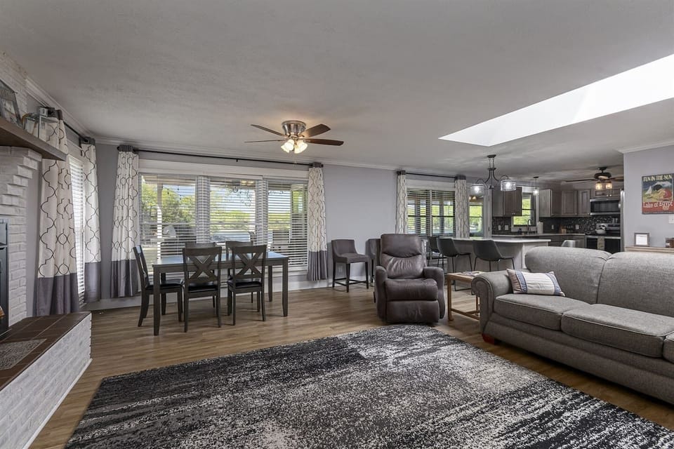 A cozy living room with a comfortable couch, a coffee table, and a warm fireplace.