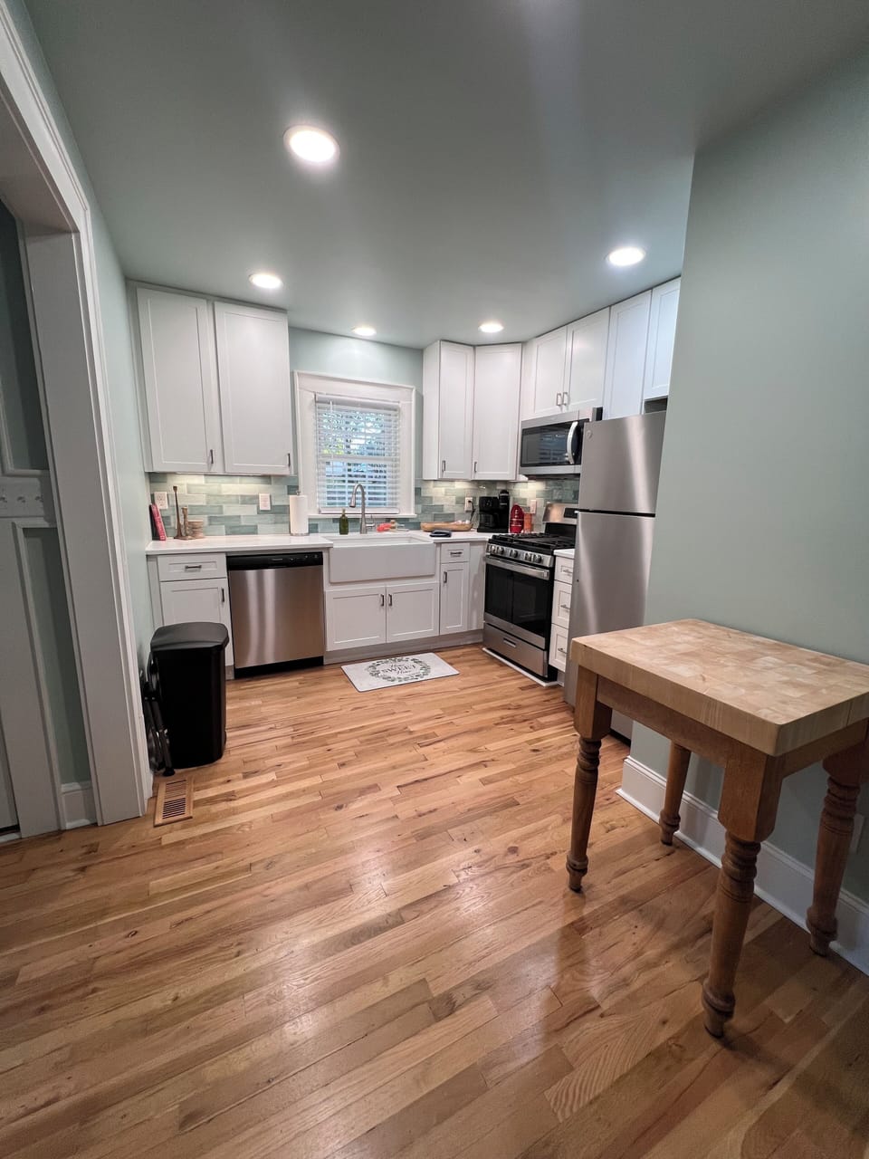 Well-appointed kitchen with gas stove and butcher block island.