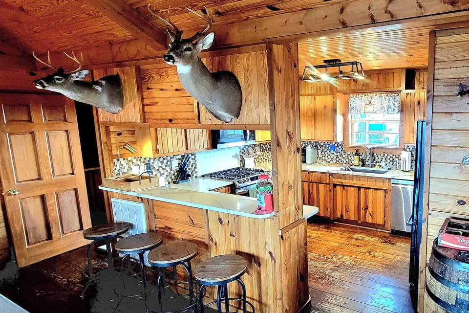 Kitchen bar with 4 swivel stools.  Enjoy an afternoon snack or a beverage!