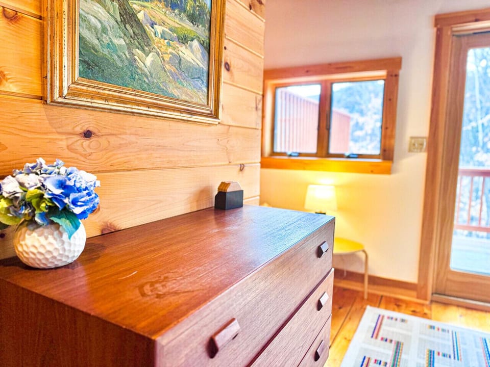 A beautifully styled space with decorative artwork, books, and unique displays adding character and charm.